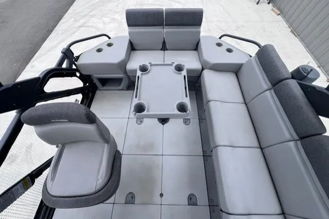 Slide: The Image of 2022 Seadoo Switch interior with gray seating and table, featuring cup holders. - 6