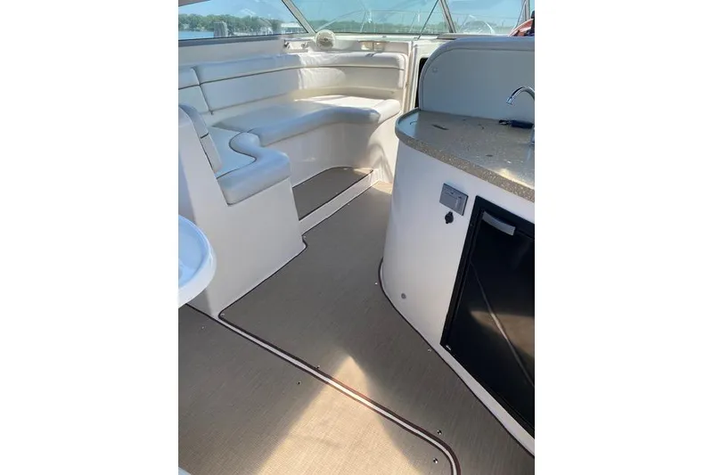 Slide: The Image of 2005 Rinker Fiesta Vee 320 interior with seating and kitchenette. - 13