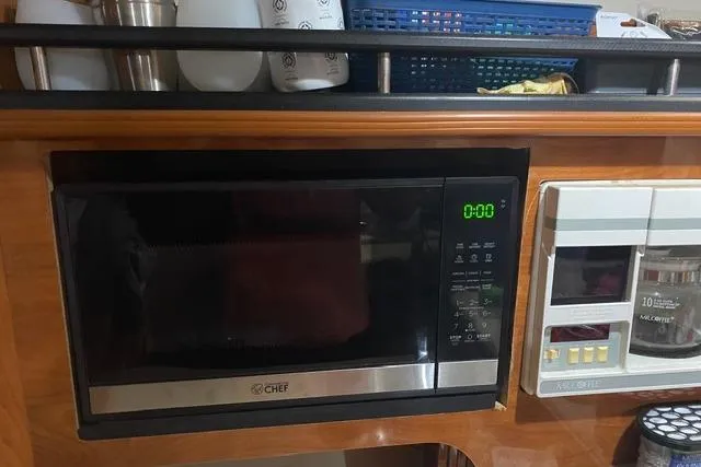 Slide: The Image of Microwave and appliances in 2005 Rinker Fiesta Vee 320 boat kitchen area. - 14