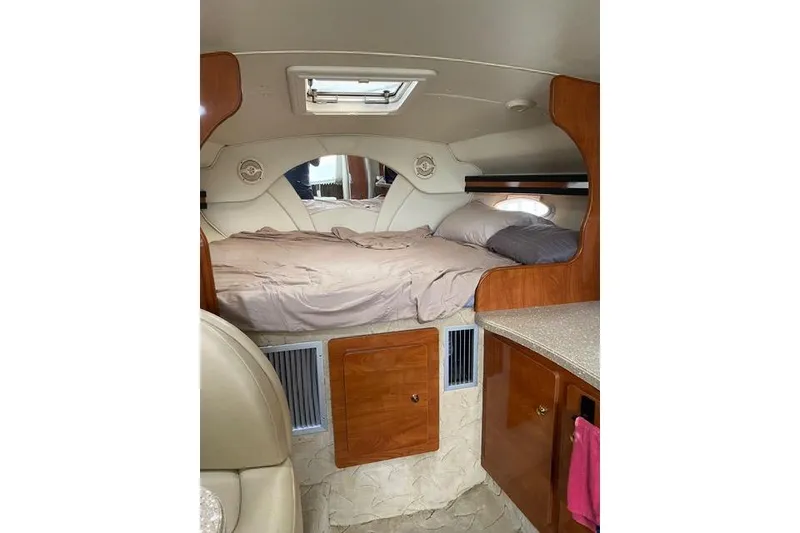 Slide: The Image of Interior cabin of 2005 Rinker Fiesta Vee 320 with cozy bed and wooden cabinetry. - 16