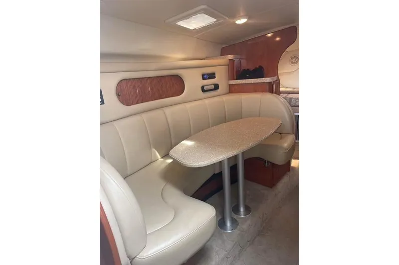 Slide: The Image of Interior of 2005 Rinker Fiesta Vee 320 boat with beige seating and table. - 18