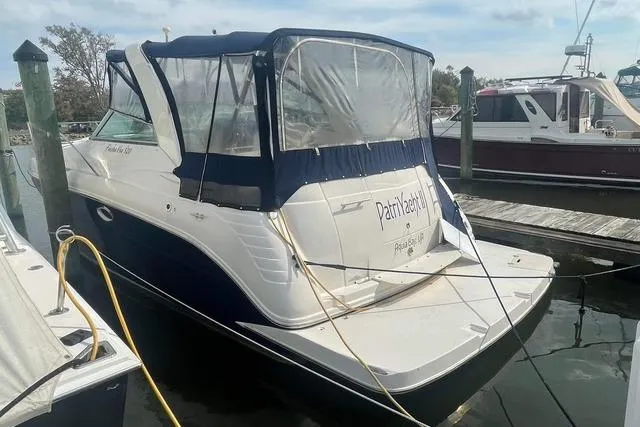 Slide: The Image of 2005 Rinker Fiesta Vee 320 boat docked at marina with protective cover. - 2