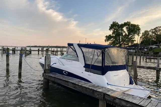 Slide: The Image of 2005 Rinker Fiesta Vee 320 docked at a serene marina during sunset. - 3