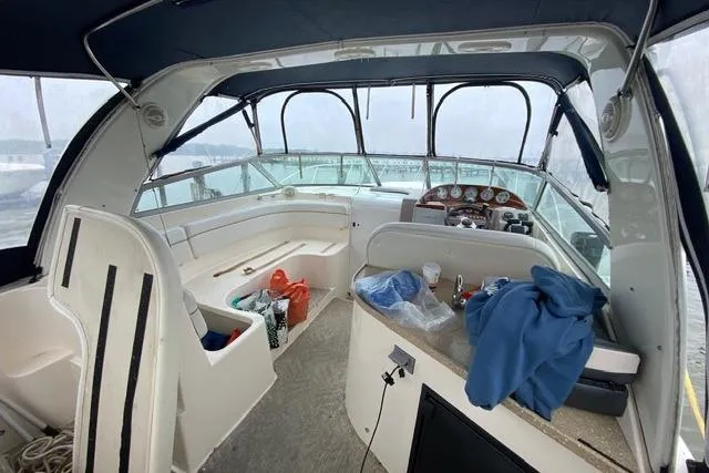 Slide: The Image of 2005 Rinker Fiesta Vee 320 boat interior with helm, seating, and covered cockpit. - 5