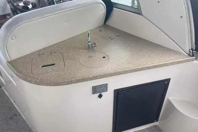 Slide: The Image of 2005 Rinker Fiesta Vee 320 boat interior with kitchenette and sink. - 7