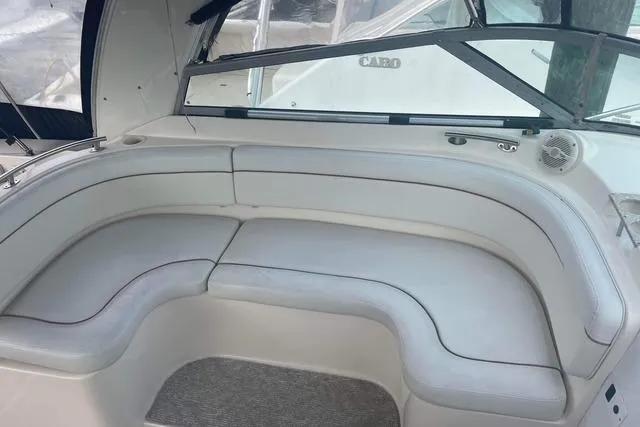 Slide: The Image of 2005 Rinker Fiesta Vee 320 boat interior with white cushioned seating. - 9