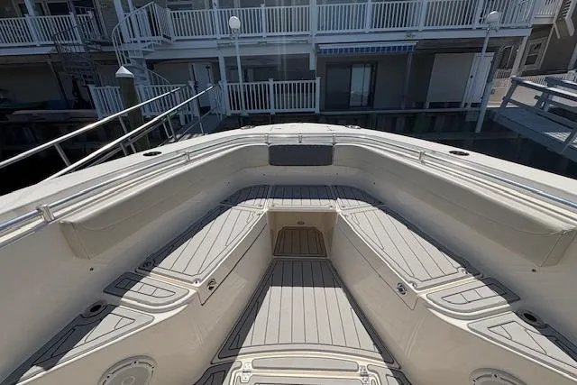 Slide: The Image of 2019 Cobia 280 Center Console boat deck with spacious seating and storage compartments. - 12