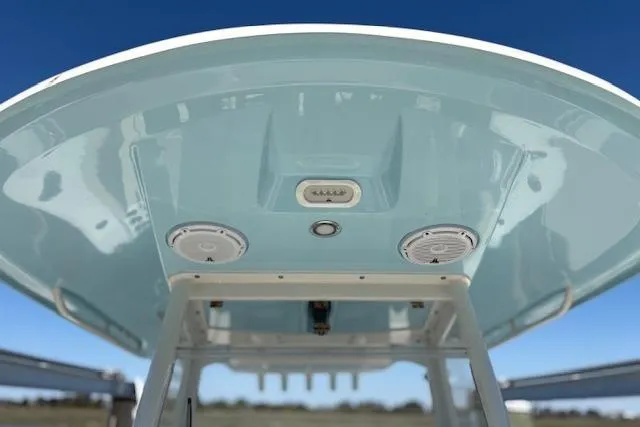 Slide: The Image of 2019 Cobia 280 Center Console boat's underside view with speakers and lights. - 14