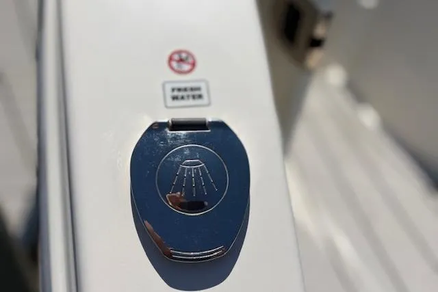 Slide: The Image of 2019 Cobia 280 Center Console fresh water shower control on boat deck. - 15