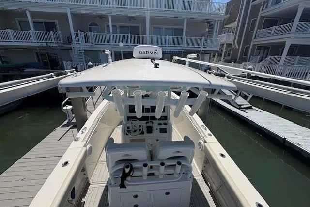 Slide: The Image of 2019 Cobia 280 Center Console boat docked, featuring Garmin navigation system. - 22