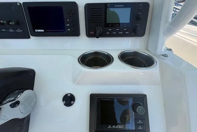 Slide: The Image of Control panel of 2019 Cobia 280 Center Console with Garmin and JL Audio systems. - 26