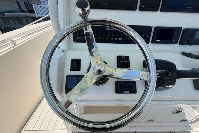 Slide: The Image of Steering wheel of a 2019 Cobia 280 Center Console boat, featuring modern controls and displays. - 27