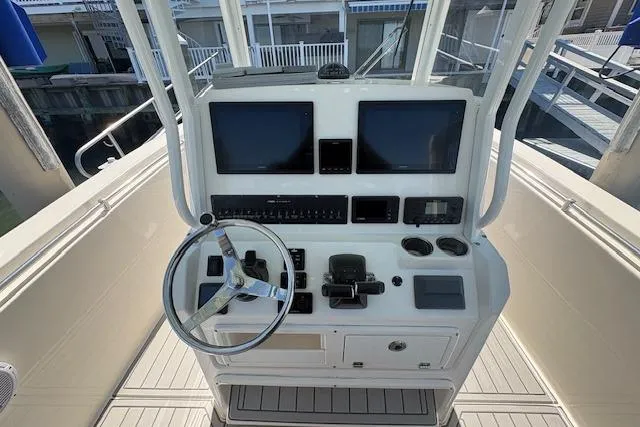 Slide: The Image of 2019 Cobia 280 Center Console helm with dual screens and steering wheel. - 28
