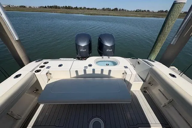 Slide: The Image of 2019 Cobia 280 Center Console boat with twin engines on calm water. - 30