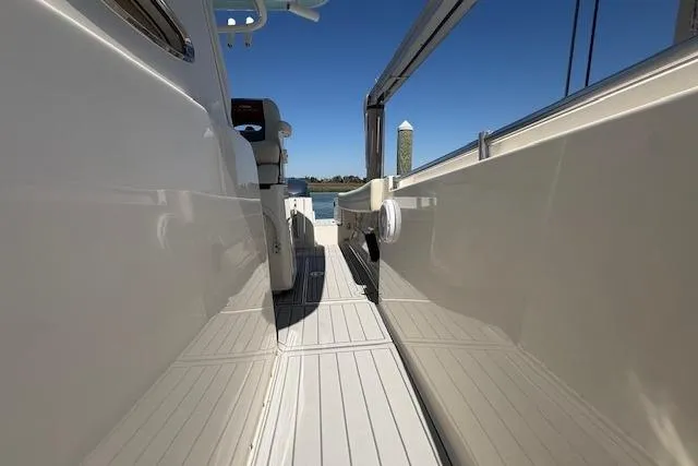 Slide: The Image of 2019 Cobia 280 Center Console boat deck with sleek design and open walkway. - 32