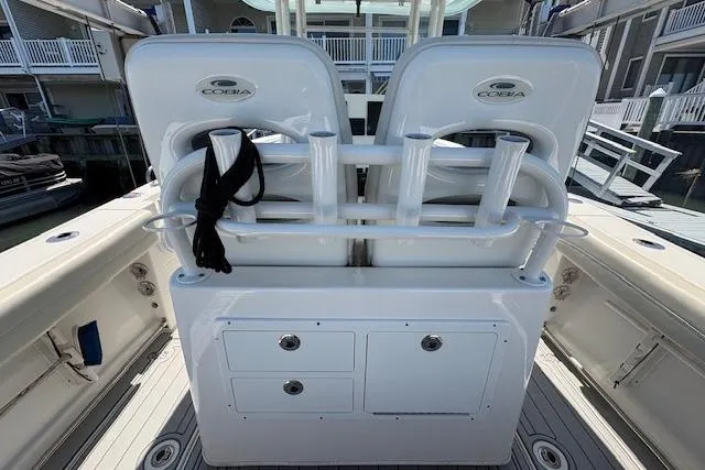 Slide: The Image of 2019 Cobia 280 Center Console boat with rod holders and storage compartments. - 33