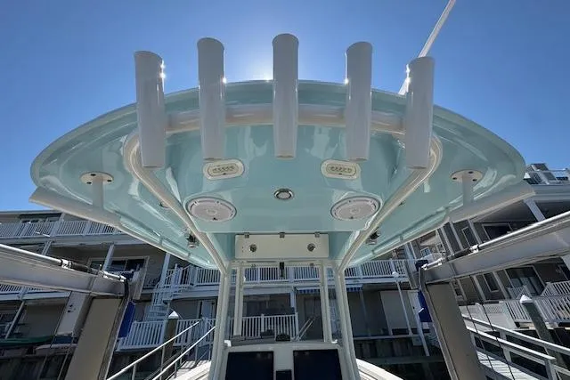 Slide: The Image of 2019 Cobia 280 Center Console boat with rod holders and blue sky background. - 34