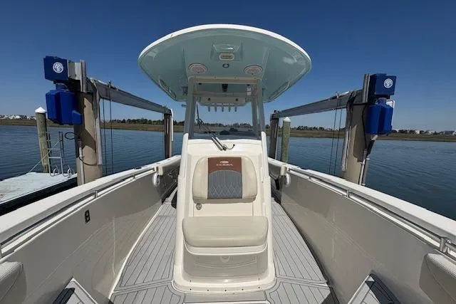 Slide: The Image of 2019 Cobia 280 Center Console boat docked, showcasing spacious deck and seating. - 37