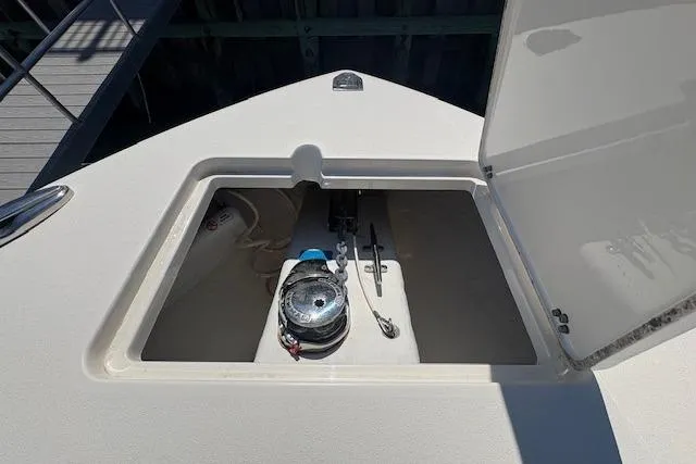 Slide: The Image of 2019 Cobia 280 Center Console anchor storage compartment with open hatch. - 38