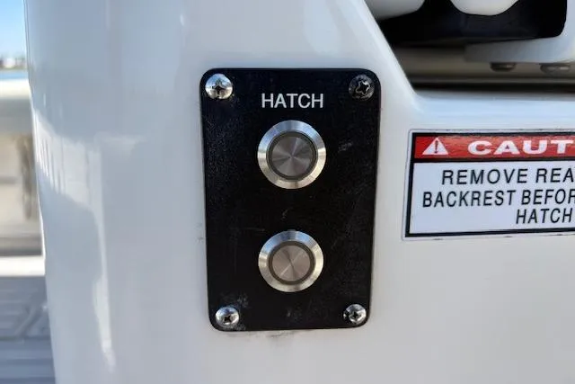 Slide: The Image of Hatch control buttons on 2019 Cobia 280 Center Console boat with caution label. - 40