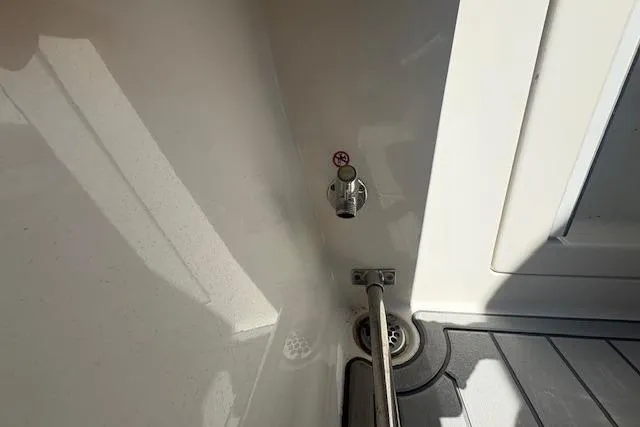 Slide: The Image of 2019 Cobia 280 Center Console boat interior detail with drain and valve. - 45