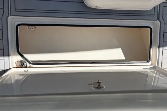 Slide: The Image of 2019 Cobia 280 Center Console storage compartment with open lid, showcasing interior space. - 50
