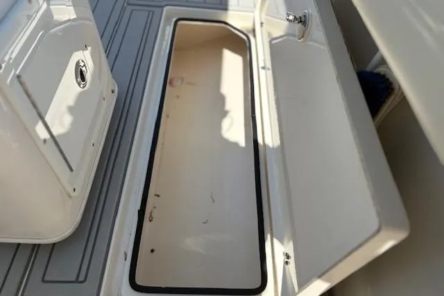 Slide: The Image of Open storage compartment on a 2019 Cobia 280 Center Console boat. - 51