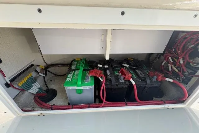 Slide: The Image of 2019 Cobia 280 Center Console battery compartment with wiring and batteries. - 52