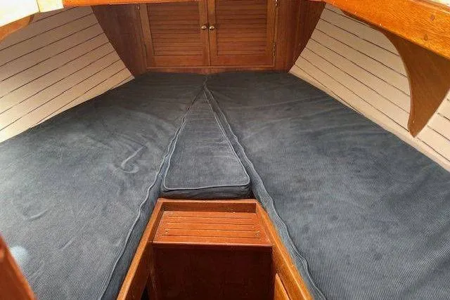 Slide: The Image of Cozy cabin interior of 1939 Alden Graves Coastwise Cutter 36 sailboat with blue cushions. - 10