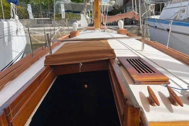 Slide: The Image of 1939 Alden Graves Coastwise Cutter 36 sailboat deck with wooden details and open hatch. - 12