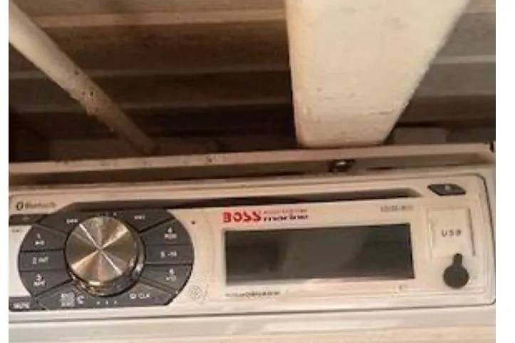 Slide: The Image of Radio system with USB and Bluetooth features, mounted under a wooden shelf. - 19