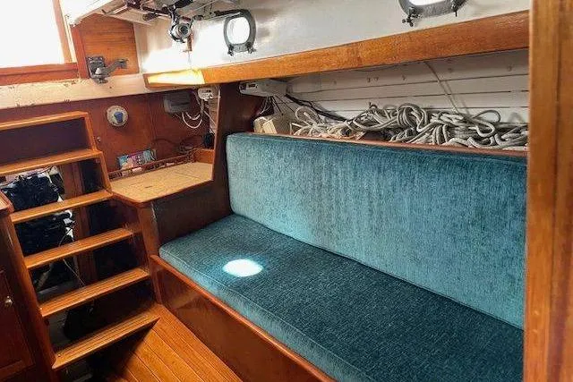 Slide: The Image of Interior of 1939 Alden Graves Coastwise Cutter 36 with blue seating and wooden accents. - 4