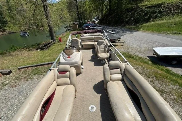 Slide: The Image of 2008 Sun Tracker Party Barge 25 Regency Edition pontoon boat docked near a scenic lake. - 11
