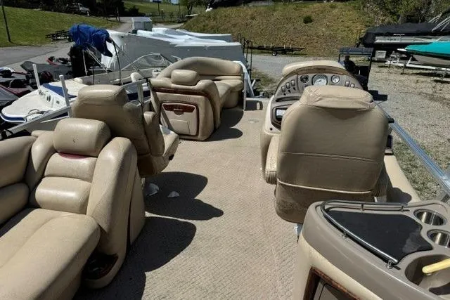 Slide: The Image of 2008 Sun Tracker Party Barge 25 Regency Edition interior with beige seating and control panel. - 9