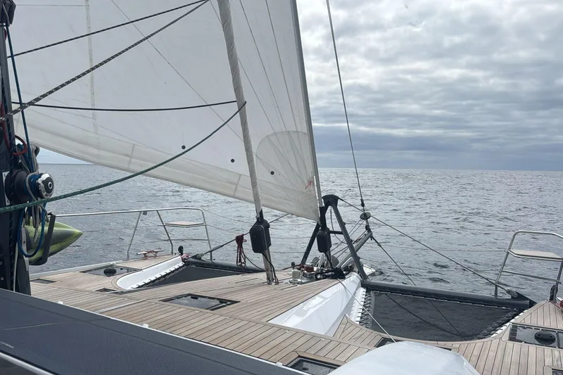 Slide: The Image of Sailing on a 2022 Privilege 510 catamaran with open sea and cloudy skies. - 7