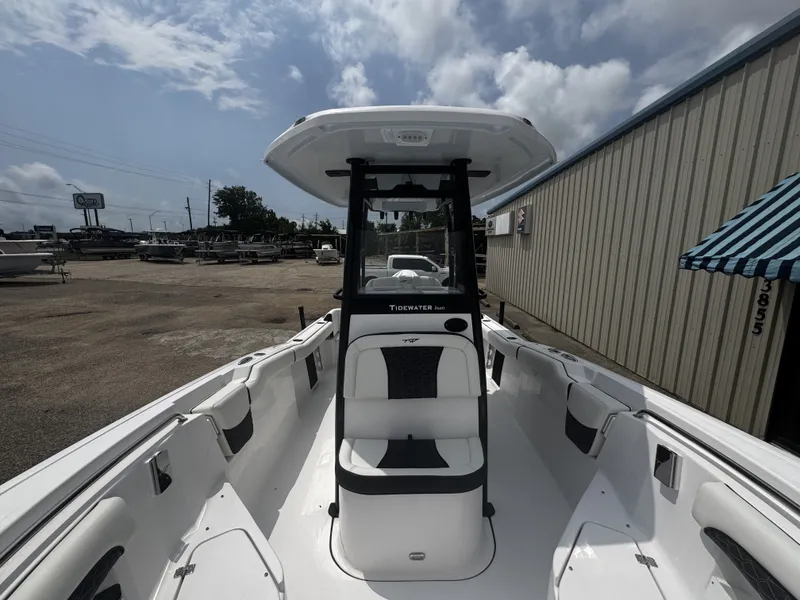 Slide: The Image of 2026 Tidewater 232 LXF boat on a lot under cloudy sky. - 13