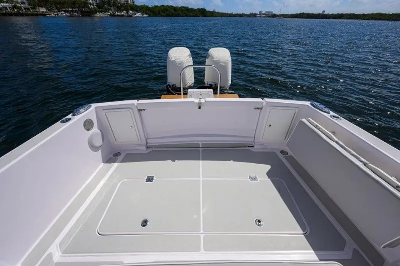 Slide: The Image of 2022 True North 34 boat deck with dual engines on a calm lake. - 31
