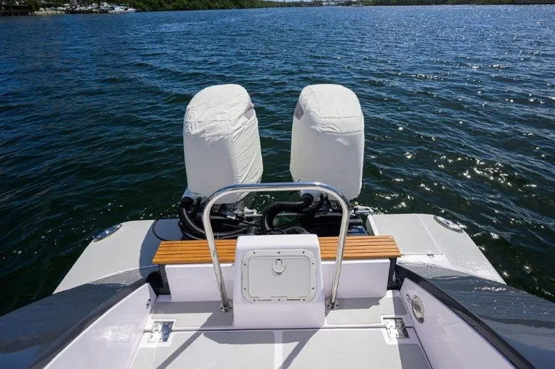 Slide: The Image of 2022 True North 34 boat with covered engines on a calm lake. - 35