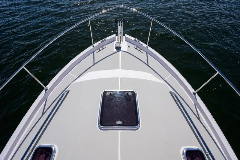 Slide: The Image of Bow view of 2022 True North 34 boat on water, showcasing sleek design and railing. - 39