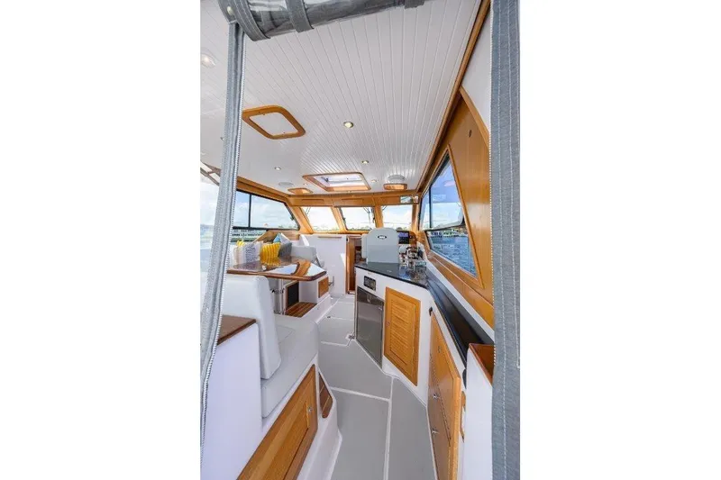 Slide: The Image of Interior of 2022 True North 34 boat with elegant wood finishes and modern amenities. - 45