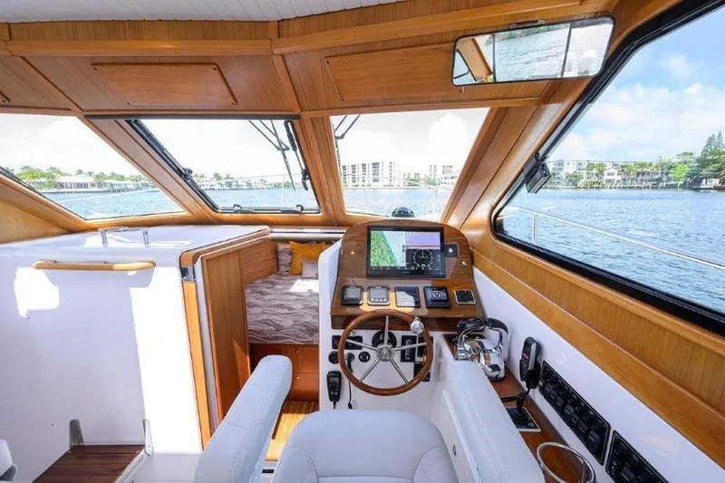 Slide: The Image of Interior of 2022 True North 34 boat with helm, navigation equipment, and cozy cabin. - 63