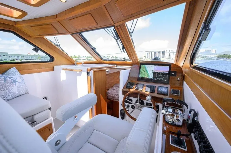 Slide: The Image of Luxurious 2022 True North 34 yacht interior with modern navigation system and plush seating. - 64