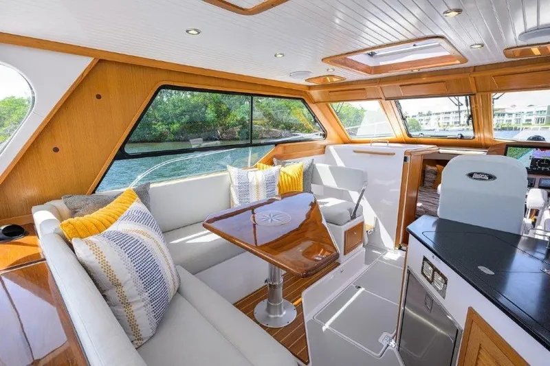 Slide: The Image of Luxurious interior of 2022 True North 34 yacht with elegant wood finish and plush seating. - 69