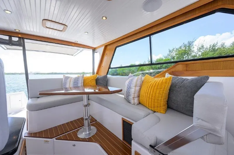 Slide: The Image of Interior of 2022 True North 34 boat with cozy seating and scenic window view. - 70