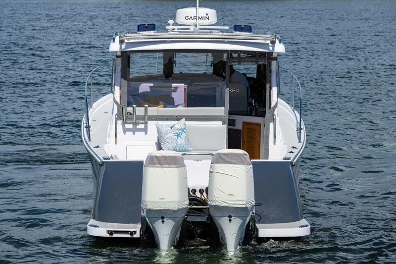 Slide: The Image of 2022 True North 34 boat with dual engines on water, rear view. - 8