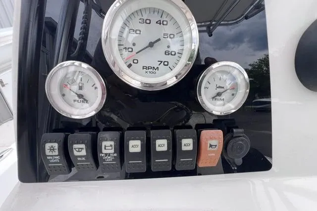 Slide: The Image of 2021 Sportsman Tournament 234 SBX Bay Boat dashboard with gauges and switches. - 10