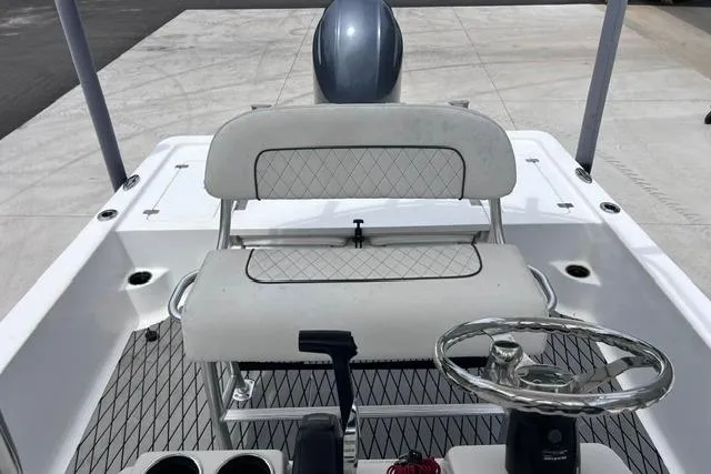 Slide: The Image of 2021 Sportsman Tournament 234 SBX Bay Boat interior with steering wheel and seating. - 6