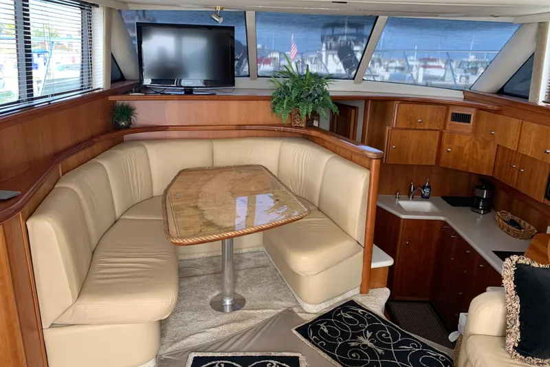Slide: The Image of Luxurious interior of 2002 Silverton 42 Convertible yacht with plush seating and elegant wood finishes. - 10