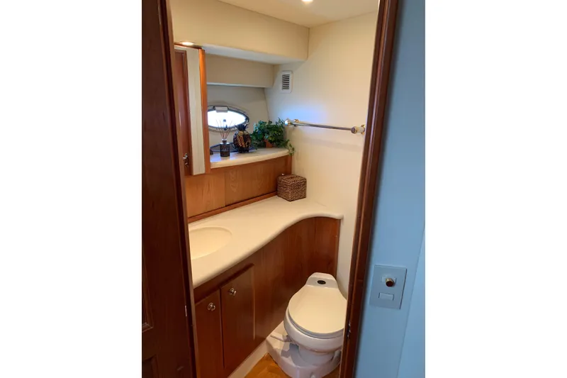 Slide: The Image of Luxurious bathroom in 2002 Silverton 42 Convertible yacht with wooden cabinetry and modern fixtures. - 3
