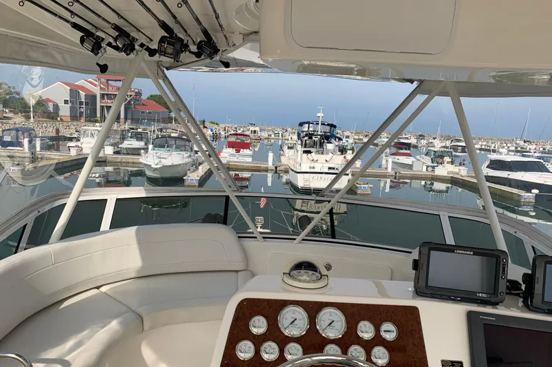 Slide: The Image of Helm view of a 2002 Silverton 42 Convertible yacht docked at a marina. - 4